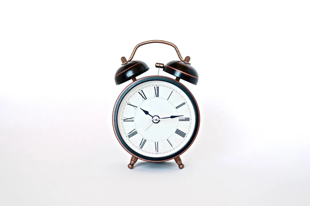 A vintage-style twin-bell alarm clock on a white background